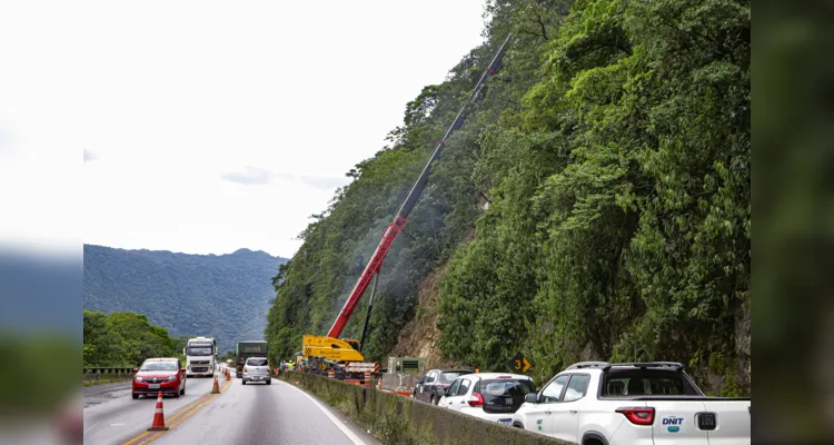 Guindastes realizam a recuperação do morro na BR 277, sentindo litoral paranaense, nas proximidades do viaduto do padre.