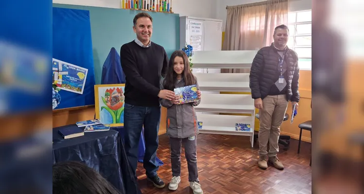 No evento de entrega dos materiais, cada aluno recebeu o seu exemplar e os familiares também estiveram presentes, assim como os representantes da Frísia Cooperativa.