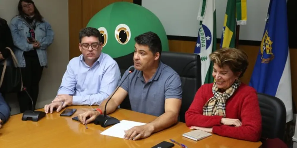 Desde o último sábado (03), o Aterro Botuquara não é mais destino final dos resíduos sólidos urbanos (RSU) gerados em Ponta Grossa. Com a contratação de novos destinos finais para os RSU do município, através do credenciamento de empresas com aterro sanitário privado e licenciado para serviços de recepção e destinação final de resíduos urbanos, a Prefeitura encerrou as operações do Aterro Botuquara. Dessa forma, os RSU gerados na cidade estão tendo destinação correta, em aterros sanitários que fazem o tratamento adequado.

“Hoje estamos anunciando a resolução de um problema histórico da cidade, que há mais de 50 anos vinha depositando seus resíduos em aterro a céu aberto, sem os tratamentos adequados. Com a modalidade de credenciamento, estamos garantindo que o lixo seja devidamente destinado, em aterros sanitários com os tratamentos ambientalmente corretos e por um valor justo. Essa vitória é resultado de todo o trabalho desempenhado pela equipe da Secretaria de Meio Ambiente, que desenvolveu o modelo de credenciamento e planilha de custos e que, com a educação ambiental e a ampliação da coleta seletiva, vem sensibilizando parte cada vez maior da população para a separação dos resíduos recicláveis”, comemora o prefeito, Marcelo Rangel.

A Prefeitura abriu, em novembro de 2018, chamada pública para credenciamento de empresas para a contratação dos serviços de recepção e destinação final de resíduos urbanos em um aterro sanitário. Com uma planilha de preços elaborada por técnicos da Prefeitura, o valor a ser pago pela tonelada de resíduo será de R$ 98,73, pelo prazo máximo de 60 meses, com uma previsão para destinação de 7.250 t/mês. Pela modalidade de credenciamento, mais de uma empresa pode habilitar-se para receber e dar destinação final ao RSU de Ponta Grossa, desde que atenda as exigências do projeto básico.

“Desde janeiro, uma pequena parte dos resíduos gerados na cidade já vinham sendo destinadas para um aterro em Curitiba, conforme capacidade da empresa. Com um novo credenciamento realizado nas últimas semanas, de aterro privado licenciado que tem condições de gerenciar uma capacidade maior, o Botuquara não está recebendo mais nenhum caminhão de resíduos desde o último sábado. Com a solução deste problema, a destinação correta dos resíduos sólidos de Ponta Grossa para um aterro sanitário devidamente licenciado, podemos agora começar a pensar em caminhos para recuperar a área do Botuquara”, aponta o secretário de Meio Ambiente, Paulo Barros.

O prefeito Marcelo Rangel anunciou oficialmente o encerramento das operações do Aterro Botuquara em coletiva para a imprensa na tarde desta segunda (05), com a presença do secretariado municipal, a equipe da SMMA e a presidente do Conselho Municipal do Meio Ambiente (Comdema), Caroline Schoenberger.

“Hoje estamos vivendo um momento histórico, vendo o efetivo encerramento do Botuquara. Trata-se de um passo muito grande para preservação do meio ambiente. O Comdema realiza reuniões frequentes e sempre contou com a pré-disposição da SMMA para esclarecimentos de dúvidas, para receber sugestões na busca pela destinação devida dos resíduos. O conselho deve continuar com esse importante trabalho de mediar as demandas da população junto ao poder público”, destaca Schoenberger.

Entre as medidas que colaboraram para a resolução da destinação final dos resíduos gerados em Ponta Grossa estão a formatação do modelo de credenciamento das empresas; a ampliação da coleta seletiva porta a porta; ampliação dos Pontos de Entrega Voluntária (PEVs); compra de equipamentos para as associações de recicladores; intensificação da educação ambiental; parcerias com BO Packing, Assocampos, Apras, Shopping Palladium; e outras ações.

A Secretaria de Meio Ambiente também tem planos para melhorar cada vez mais o gerenciamento de resíduos, com ampliação da coleta seletiva para mais setores, investimento em novos equipamentos e maquinário para as associações de recicladores, implantação de aplicativo para acompanhamento do caminhão de coleta e realização de estudo para implantação de usina de resíduos sólidos orgânicos.

Após o encerramento das atividades do Botuquara, devem ser realizados estudos de investigação de passivo ambiental para conhecer quais serão as medidas técnicas necessárias para fazer o monitoramento e remediação da área contaminada.