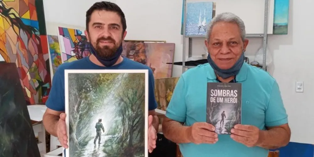 Eduardo Urba Neto ao lado de Sidney Mariano, respectivamente escritor e artista da ilustração da obra: "Sombras de um Herói".