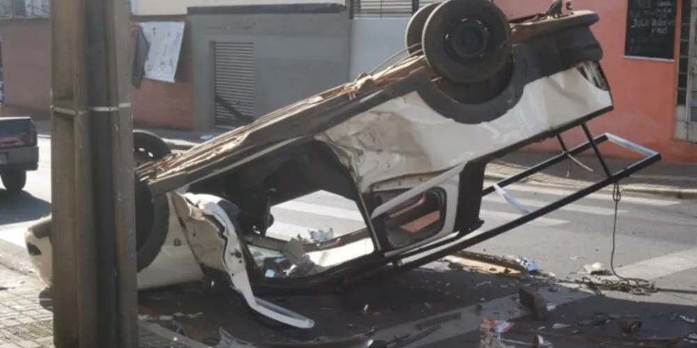 Com a força da batida, Fiat Strada acabou capotando no local