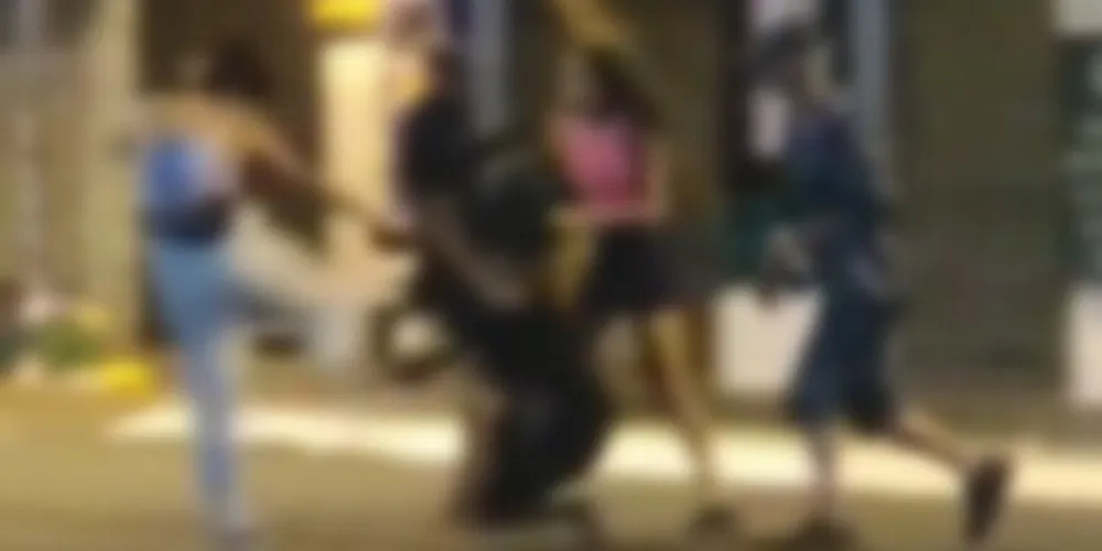 Nas imagens, é possível observar uma pessoa em situação de rua sendo agredida por uma mulher