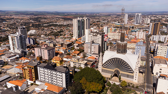 Aerial view of the city of Ponta Grossa with its buildings and Santana Cathedral, on a sunny day.