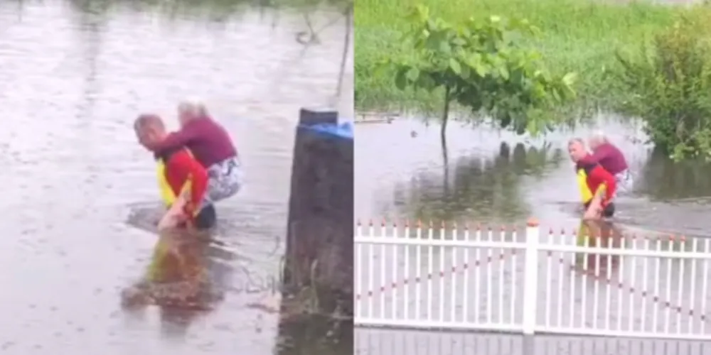 Nas imagens, é possível ver o agente carregando a idosa nas costas.