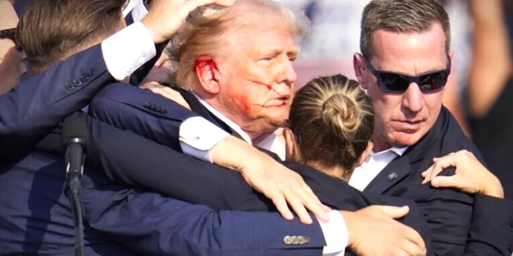 Ao centro e ferido o ex-presidente dos Estados Unidos, Donald Trump