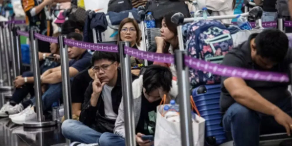 Passageiros esperam para fazer check-in no Aeroporto Internacional de Hong Kong nesta sexta-feira após apagão cibernético