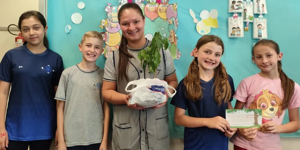 A turma realizou a entrega de mudas de árvores, simbolizando o compromisso com o cuidado com a natureza