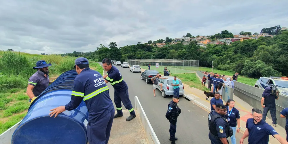 Agentes públicos distribuindo caixas d'água na Vila Nova.
