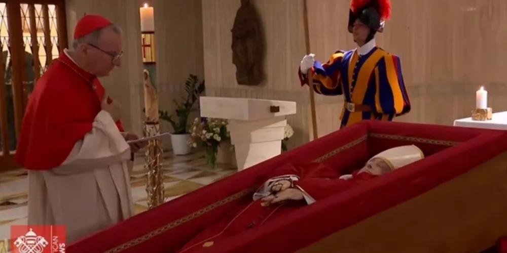 O secretário de estado, cardeal Pietro Parolin, reza ao lado do corpo de Francisco