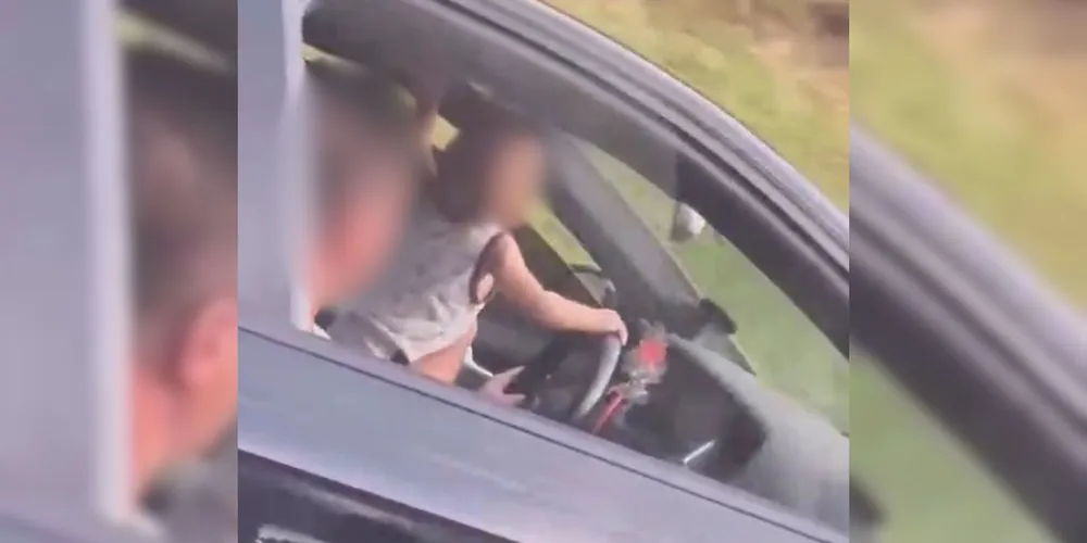 Bebê estava em pé, no banco do motorista, com as mãos no volante