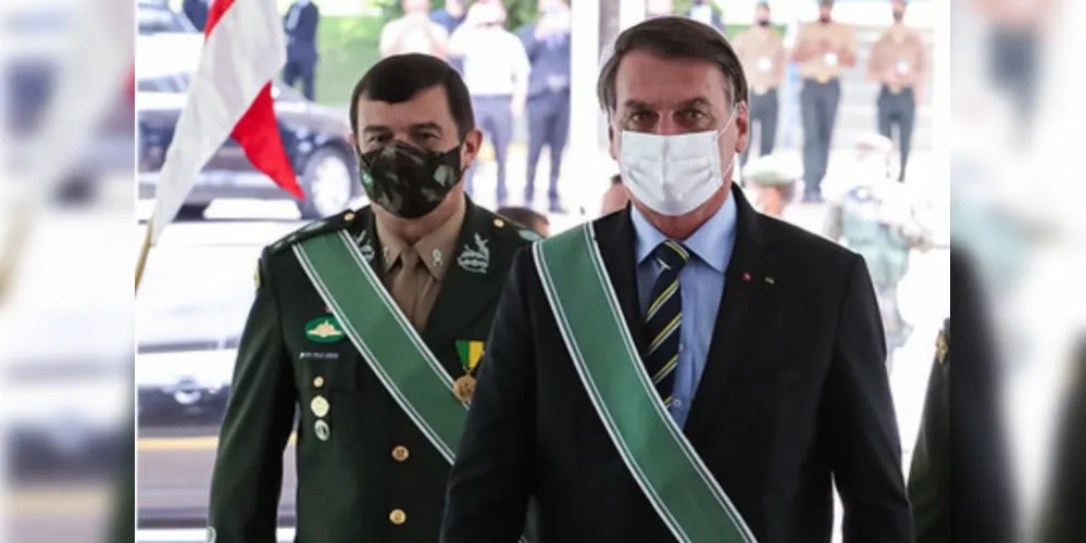 À esquerda, o comandante geral do Exército, e à direita o presidente do Brasil, Bolsonaro.
