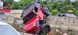 Jeep ficou pendurado em uma mureta que divide as pistas, no bairro Atuba, em Curitiba.
