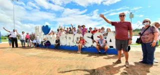 Grupo de turistas carioca durante City Tour em Ponta Grossa registra presença junto ao letreiro da cidade no Lago de Olarias.